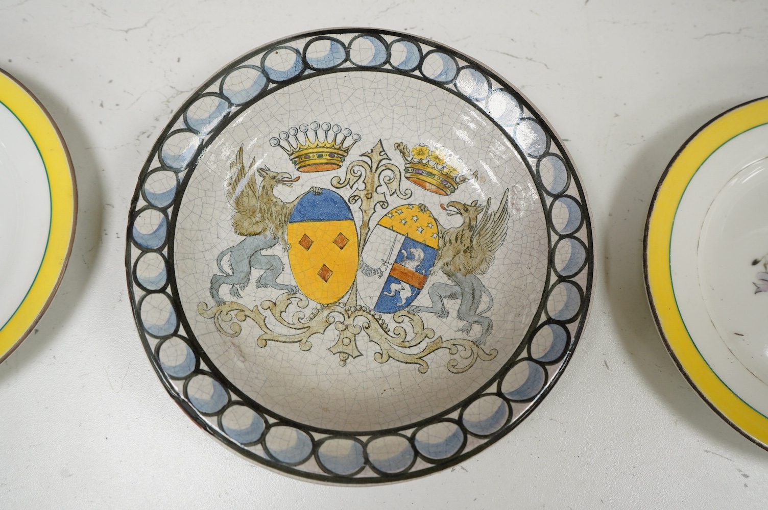 Two 19th century Russian Kornilov Brothers armorial plates and another pottery plate, largest 18cm in diameter. Condition - fair